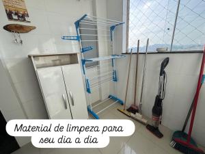 a kitchen with a shower with tools on the wall at Apartamento super central até 9 pessoas in Divinópolis +32 photos