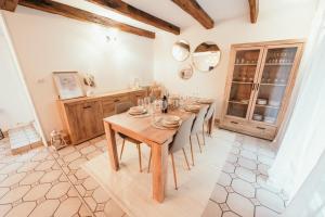 a dining room with a wooden table and chairs at The Champenoise Jacuzzi - Vineyard in Verzenay