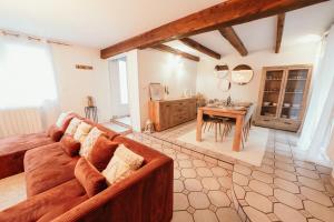 a living room with a couch and a table at The Champenoise Jacuzzi - Vineyard in Verzenay +62 photos