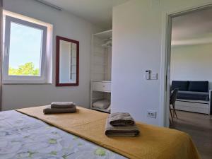 a bedroom with a bed with two towels on it at Casa di Castello in Mali Lošinj