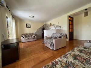 a living room with two couches and a kitchen at Villa Maša in Zelenika