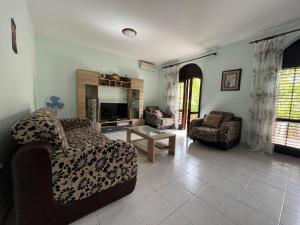 a living room with a couch and a chair at Villa Maša in Zelenika