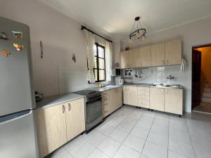 a kitchen with wooden cabinets and stainless steel appliances at Villa Maša in Zelenika +6 photos