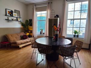 a living room with a table and chairs and a couch at Casa Elburg in Elburg