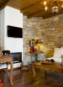a living room with a stone wall at Minelska Apartments in Kala Nera +28 photos