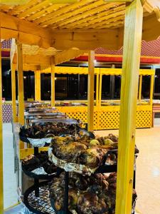 a row of trays of food on a table at Beauty Wadi Rum Luxury Camp in Wadi Rum +55 photos
