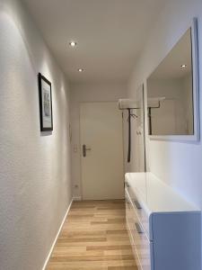 a white bathroom with a sink and a mirror at Apartment Düsseldorf Nord in Düsseldorf +17 photos