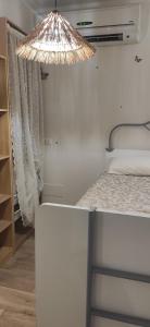a bedroom with a bed with a light above it at Bio house posto auto aria condizionata in Bologna +4 photos