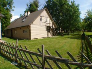 an old barn with a fence in front of it at suur saunaga puhkemaja in Kipi