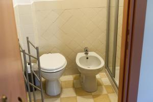a bathroom with a toilet and a bidet at Viale Mezzetti - 1.3 by Ospitaci in Foligno