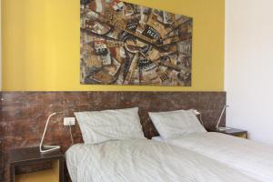 a bedroom with a bed and a painting on the wall at Viale Mezzetti - 1.3 by Ospitaci in Foligno