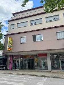 a large building with windows on a street at Apartman Kovač in Posušje