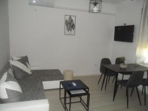 a living room with a couch and a table at Appartments with breakfast "Jagoda" in Banjol