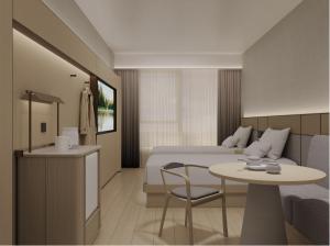 a hotel room with a bed and a table and chair at JI Hotel Beijing Changping Nanshao Subway Station in Beijing