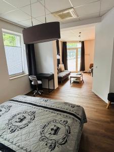 a bedroom with a bed and a living room at Top Appartement in Bremerhaven +7 photos