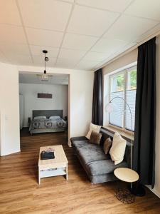 a living room with a couch and a bed at Top Appartement in Bremerhaven