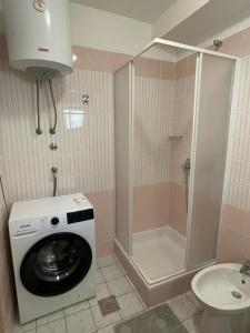 a bathroom with a washing machine and a toilet at Studio Apartman Bubi in Nečujam +35 photos