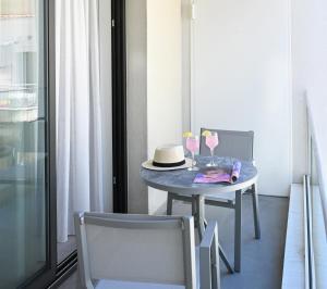 a table with a hat and two glasses on it at Icon Central SKG in Thessaloniki +51 photos