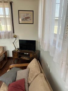 a living room with a couch and a television at Freetown's most comfortable in Freetown