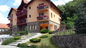 a building with flower boxes on the balconies at Pensiunea Fortuna in Sovata