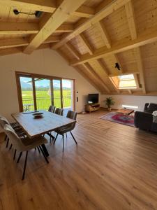 a large living room with a wooden table and chairs at Gams im Glück in Hopferau +9 photos