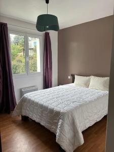 a bedroom with a white bed and a window at Maison charmante avec balcon près de Foulerot - 85 m² in Saint-Georges-dʼOléron