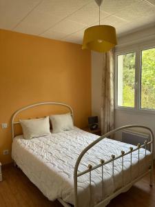a bedroom with a bed with white sheets and a window at Maison charmante avec balcon près de Foulerot - 85 m² in Saint-Georges-dʼOléron +29 photos