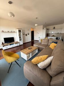 a living room with a couch and a table at Sargo Apartman Bar in Bar