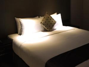 Ένα ή περισσότερα κρεβάτια σε δωμάτιο στο Geno Hotel Shah Alam