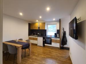 a kitchen with a dining room table and a television at Schildetal Apartment's in Vellahn