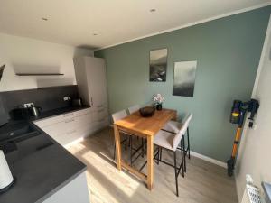 a kitchen with a wooden table and chairs in a room at Cottage Cozy Gästehaus in Goslar