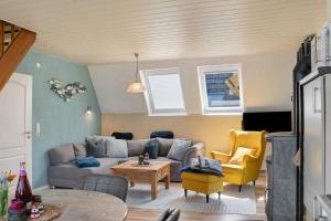 a living room with a couch and a table at Haus Lotte in Wittmund