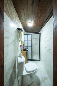 a bathroom with a white toilet and a mirror at KARAGÜL Hotel in Urfa +80 photos