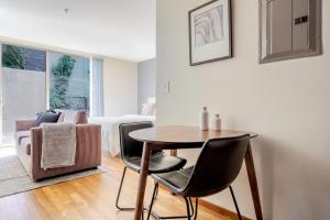 a living room with a table and chairs and a couch at Blueground Brighton balcony nr Seward Park SEA-874 in Seattle +24 photos