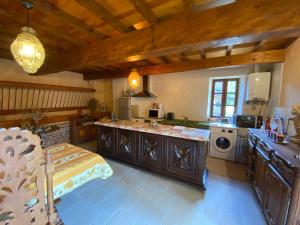 a kitchen with a sink and a washing machine at L'Ancienne écurie in Canals