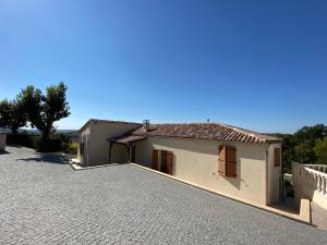a house with a driveway in front of it at Les Tilleuls in Tréjouls +5 photos