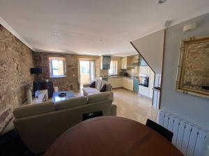 a living room with a couch and a table at Casa O Curruncho 3000 in Vilagarcia de Arousa