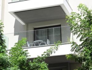a balcony of a house with chairs on it at Icon Central SKG in Thessaloniki