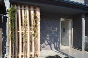 a facade of a building with vertical plants on it at Kyostay Iroha Toji Annex in Kyoto