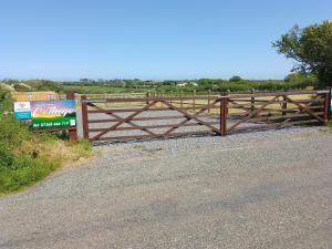a wooden fence on the side of a road at Southview Wild Camping in Haverfordwest