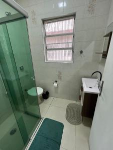 a bathroom with a glass shower and a sink at Canto do Forte - 1dorm - ate 6 Hospedes, recém reformado próximo a Av Gastronômica de melhores bares e restaurantes com musica ao vivo in Praia Grande +21 photos