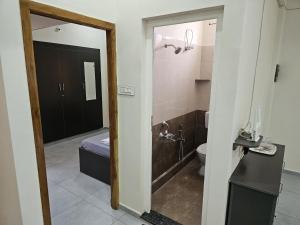 a bathroom with a toilet and a sink and a mirror at Royal Service apartment - KK Nagar Madurai in Madurai +39 photos
