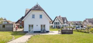 PuddeminにあるFerienhaus Wildrose in der Puddeminer Wiekの尖屋根白屋