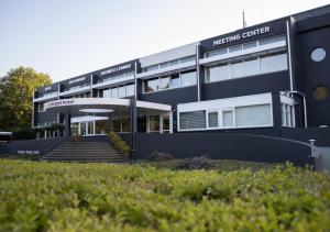 a black building with stairs in front of it at Amrâth Airport Hotel Rotterdam in Rotterdam