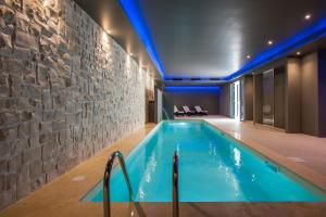 a pool in a room with a stone wall at Fortyfive Squared Hotel in Rome