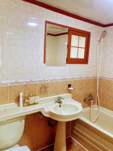 a bathroom with a sink and a toilet and a tub at A spacious, cosy, independent house in Pohang