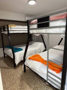 two bunk beds in a dorm room with an orange towel at Villa Catalina Beach House in Punta Santiago +43 photos