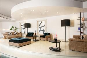 a living room with couches and chairs and a table at Hotel Mariver in Lido di Jesolo