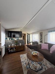 a living room with a couch and a table at 23 Chestnut Grove in Kirkcolm