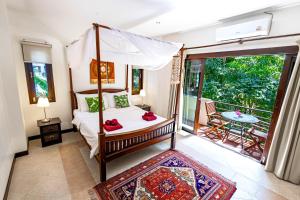 a bedroom with a canopy bed and a balcony at Maenam Hills Samui in Koh Samui  +95 photos